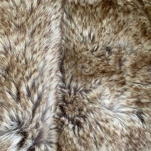 Faux fur material 
63 in by 41 inches
Can make cushions or place around tree